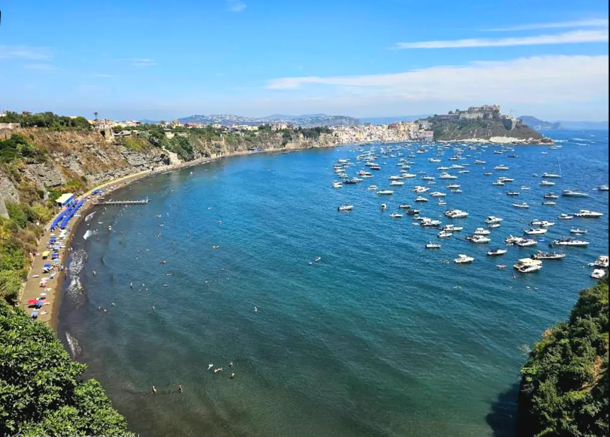 Chiaia beach in Procida with sea and view toward Terra Murata